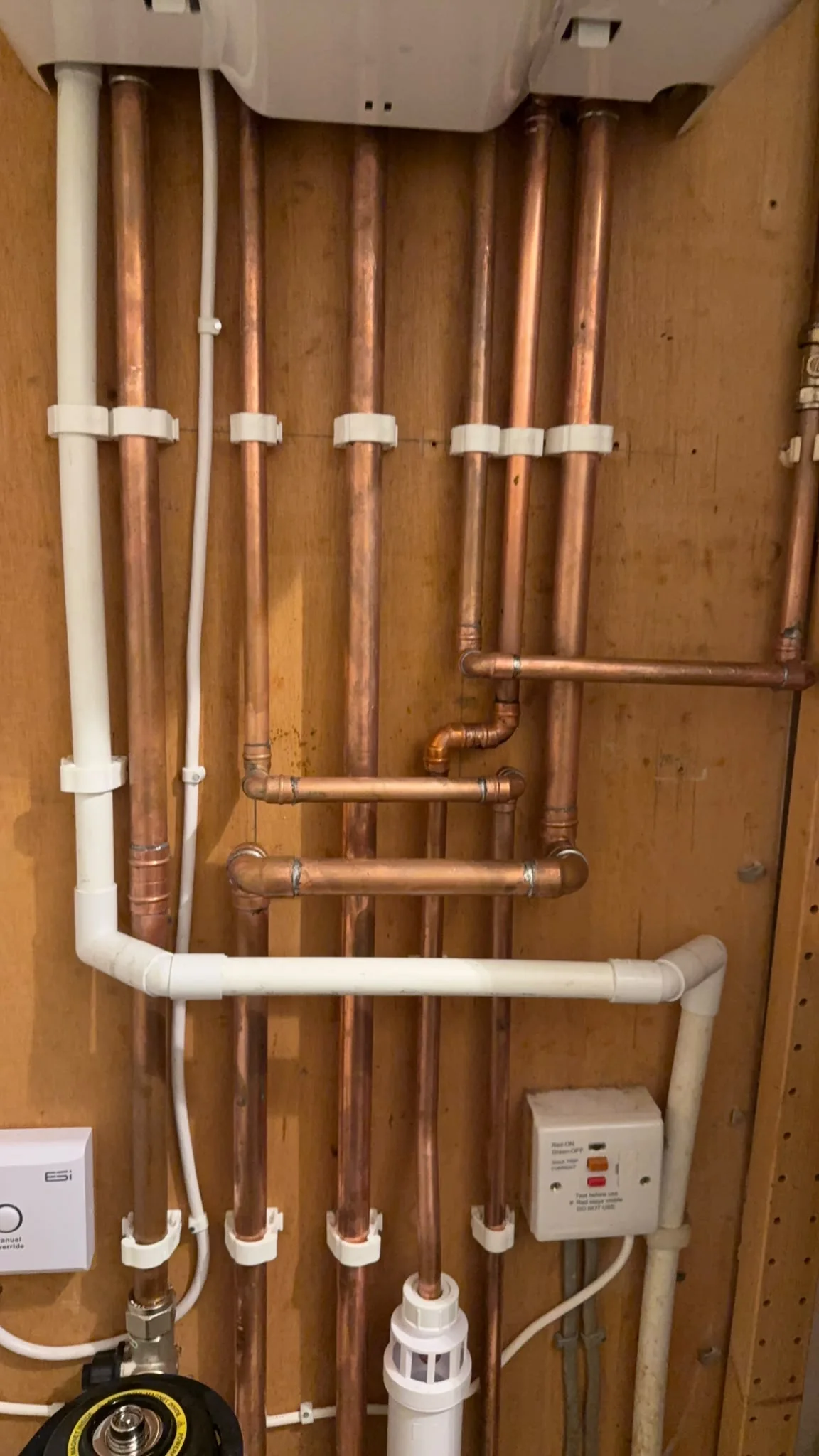 New copper pipework beneath a gas boiler installation